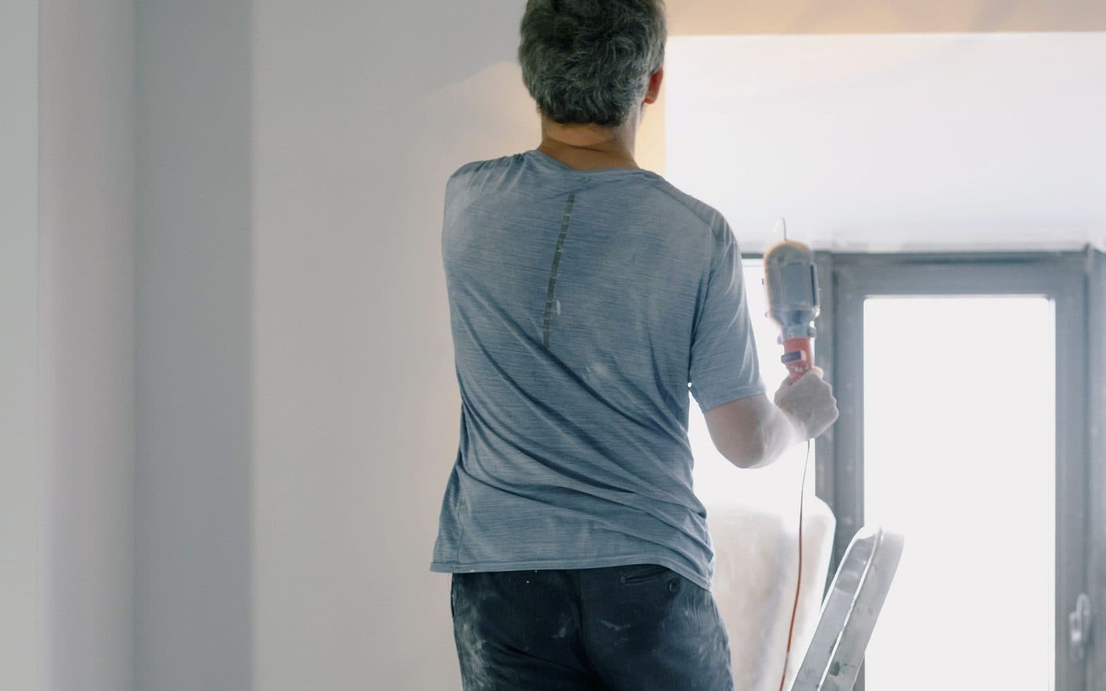 Un contratista revisando planos de renovación dentro de una casa en reparación