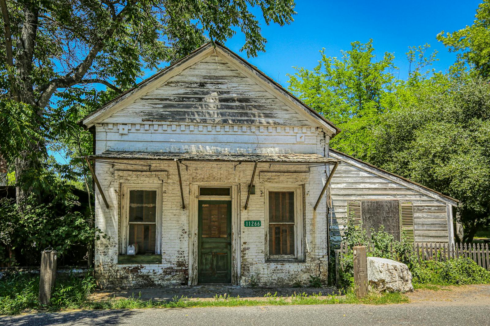 Old wooden facade of a historic abandoned house in Columbia, California, showing signs of decay.